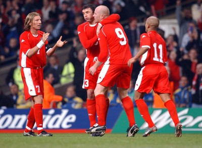 120203 - Wales v Bosnia-Herzegovina - International friendly - (L-R) Wales' Robbie Savage, Gary Speed and Robert Earnshaw look relieved as they congratulate John Hartson on his equalizer