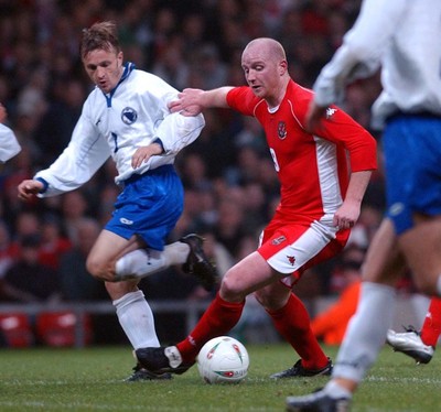 120203 - Wales v Bosnia-Herzegovina - International friendly - Wales' John Hartson gets past Vedin Music on his way to score