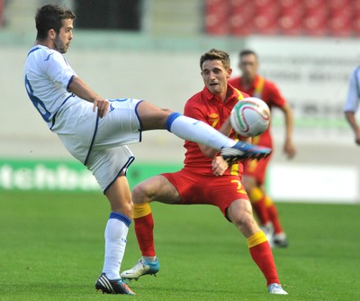 150812 - Wales v Bosnia Herzegovina, Vauxhall International Friendly -   Joe Allen of Wales, right, compete's for the ball with Miralem Pjanic of Bosnia Herzegovina   