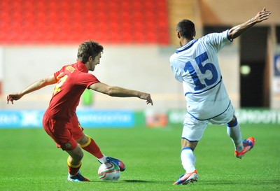 150812 - Wales v Bosnia Herzegovina, Vauxhall International Friendly -   Sam Ricketts of Wales, left, compete's for the ball with Sejad Salihovic of Bosnia Herzegovina   