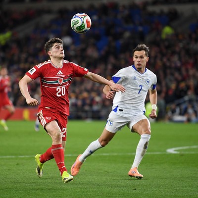 260326 - Wales v Bosnia-Herzegovina - 2026 FIFA World Cup Qualifying - Play-off Semi-final - Daniel James of Wales is challenged by Amar Dedic of Bosnia