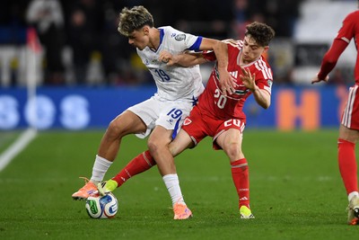 260326 - Wales v Bosnia-Herzegovina - 2026 FIFA World Cup Qualifying - Play-off Semi-final - Daniel James of Wales is challenged by Kerim Alajbegovic of Bosnia