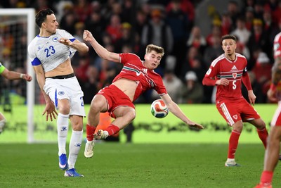260326 - Wales v Bosnia-Herzegovina - 2026 FIFA World Cup Qualifying - Play-off Semi-final - Dylan Lawlor of Wales is challenged by Haris Tabakovic of Bosnia