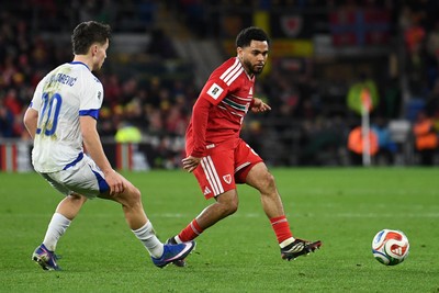 260326 - Wales v Bosnia-Herzegovina - 2026 FIFA World Cup Qualifying - Play-off Semi-final - Jay Dasilva of Wales is challenged by Ermedin Demirovic of Bosnia