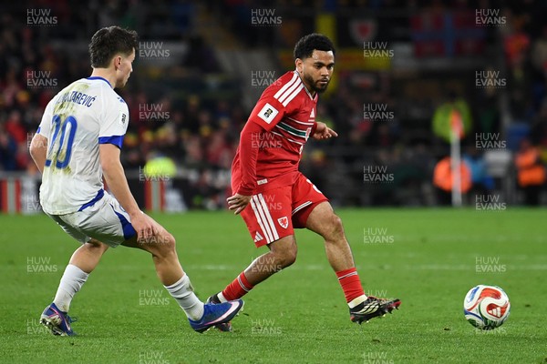 260326 - Wales v Bosnia-Herzegovina - 2026 FIFA World Cup Qualifying - Play-off Semi-final - Jay Dasilva of Wales is challenged by Ermedin Demirovic of Bosnia