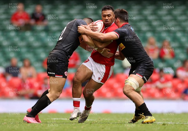 030721 - Wales v Canada - Summer Internationals - Willis Halaholo of Wales is tackled by Quinn Ngawati and Ross Braude of Canada