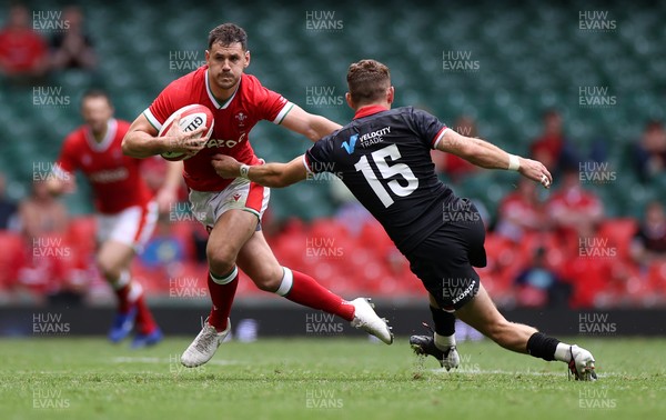 030721 - Wales v Canada - Summer Internationals - Tomos Williams of Wales is tackled by Cooper Coats of Canada