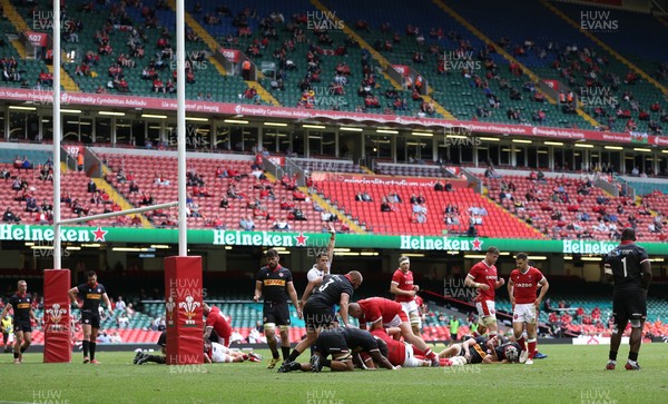 030721 - Wales v Canada, Summer International Series - Fans watch on as Elliot Dee of Wales powers over to score try