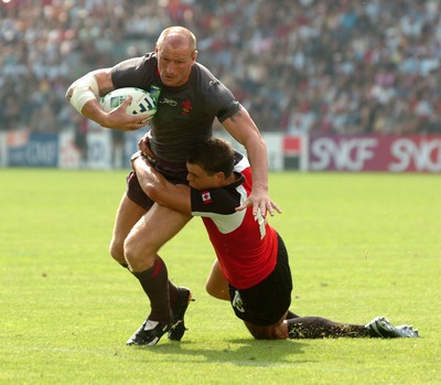 09.09.07 - Wales v Canada - Rugby World Cup 2007 - France - Wales' Gareth Thomas is tackled by Canada's Mike Pyke 