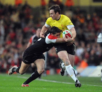 14.11.08 - Wales v Canada - Invesco Perpetual Series -  Wales' Mark Jones  is tackled by Canada's James Pritchard  
