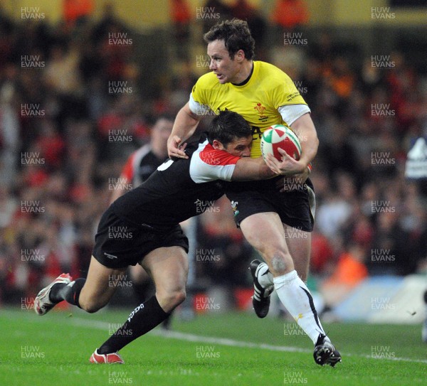 14.11.08 - Wales v Canada - Invesco Perpetual Series -  Wales' Mark Jones  is tackled by Canada's James Pritchard  