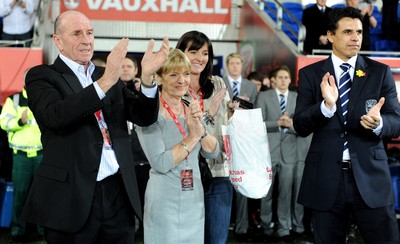 290212 - Wales v Costa Rica -Wales manager Chris Coleman looks on during the national anthems with Gary Speed's parents Roger and Carol and sister Louise Haylock(centre)