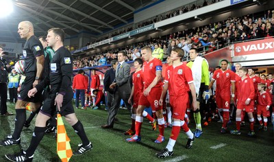 290212 - Wales v Costa Rica -Gary Speed's sons Ed and Tommy lead out Wales with captain Craig Bellamy and Aaron Ramsey