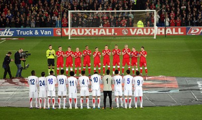 290212 - Wales v Costa Rica, The Gary Speed Memorial Match, Cardiff - The teams participate in a minutes applause at the start of the match  