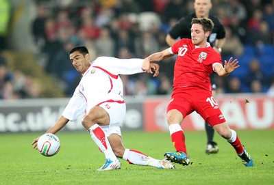 290212 - Wales v Costa Rica, The Gary Speed Memorial Match, Cardiff - Wales' Joe Allen and Costa Rica's Michael Umana compete for the ball