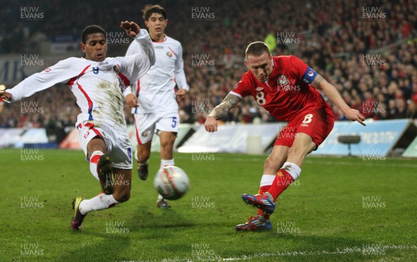 290212 - Wales v Costa Rica, The Gary Speed Memorial Match, Cardiff - Wales' Craig Bellamy  is challenged by Costa Rica's Kenny Cunningham 