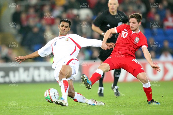 290212 - Wales v Costa Rica, The Gary Speed Memorial Match, Cardiff - Wales' Joe Allen and Costa Rica's Michael Umana compete for the ball