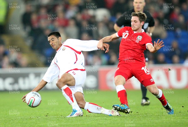 290212 - Wales v Costa Rica, The Gary Speed Memorial Match, Cardiff - Wales' Joe Allen and Costa Rica's Michael Umana compete for the ball