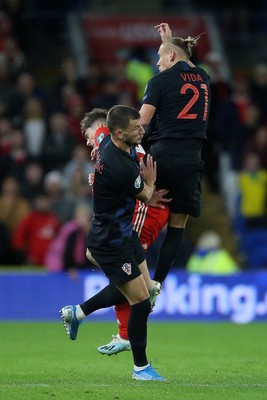 131019 - Wales v Croatia - European Championship Qualifiers - Group E - Daniel James of Wales falls to the ground after colliding with Domagoj Vida of Croatia