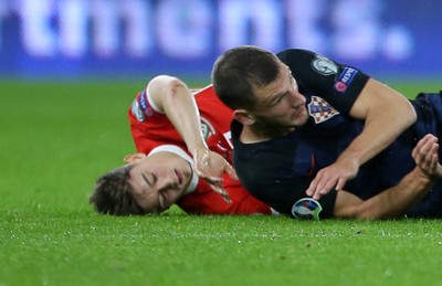 131019 - Wales v Croatia - European Championship Qualifiers - Group E - Daniel James of Wales falls to the ground after colliding with Domagoj Vida of Croatia