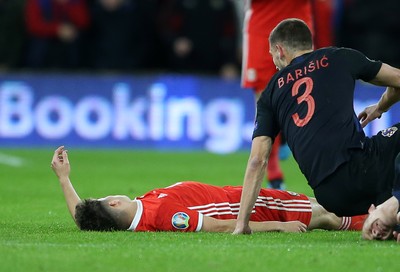 131019 - Wales v Croatia - European Championship Qualifiers - Group E - Daniel James of Wales falls to the ground after colliding with Domagoj Vida of Croatia