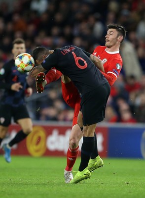 131019 - Wales v Croatia - European Championship Qualifiers - Group E - Dejan Lovren of Croatia is challenged by Kieffer Moore of Wales