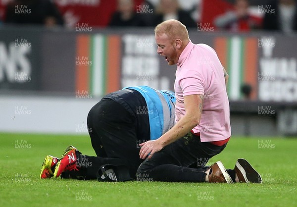 131019 - Wales v Croatia - European Championship Qualifiers - Group E - A pitch invader is wrestled with by stadium staff