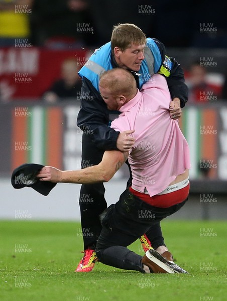 131019 - Wales v Croatia - European Championship Qualifiers - Group E - A pitch invader is wrestled with by stadium staff