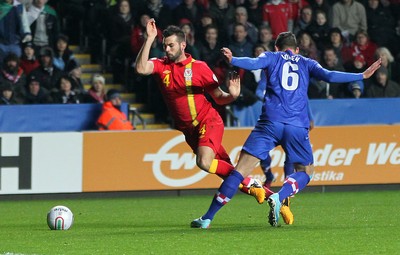 260313 - Wales v Croatia, World Cup Qualifier, Swansea - Wales' Joe Ledley is brought down by Croatia's Dejan Lovren to be awarded a penalty