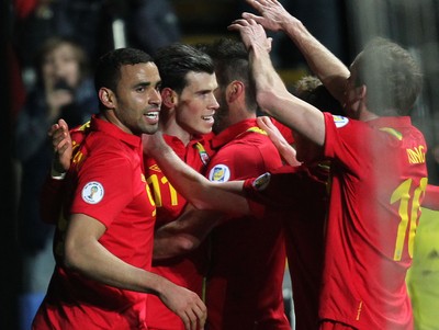260313 - Wales v Croatia, World Cup Qualifier, Swansea - Wales' Gareth Bale celebrates with team mates after he scores goal from the penalty spot
