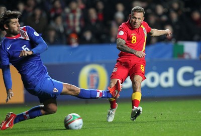 260313 - Wales v Croatia, World Cup Qualifier, Swansea - Wales' Craig Bellamy fires a shot at goal past Croatia's Vedran Corluka