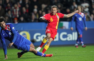 260313 - Wales v Croatia, World Cup Qualifier, Swansea - Wales' Craig Bellamy fires a shot at goal past Croatia's Vedran Corluka