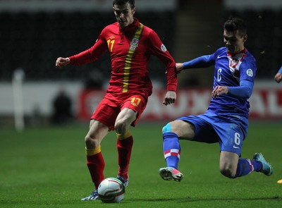 260313 - Wales v Croatia, World Cup Qualifier, Swansea - Wales' Gareth Bale is challenged by Croatia's Dejan Lovren