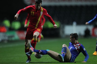 260313 - Wales v Croatia, World Cup Qualifier, Swansea - Wales' Gareth Bale is challenged by Croatia's Dejan Lovren