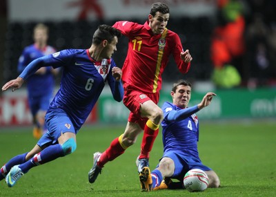 260313 - Wales v Croatia, World Cup Qualifier, Swansea - Wales' Gareth Bale is brought down by Croatia's Mateo Kovacic