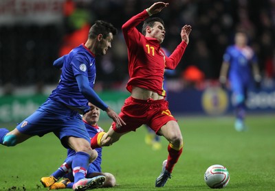 260313 - Wales v Croatia, World Cup Qualifier, Swansea - Wales' Gareth Bale is brought down by Croatia's Mateo Kovacic