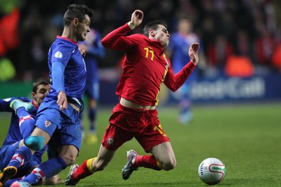 260313 - Wales v Croatia, World Cup Qualifier, Swansea - Wales' Gareth Bale is brought down by Croatia's Mateo Kovacic