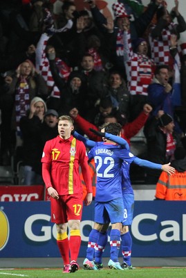 260313 - Wales v Croatia, World Cup Qualifier, Swansea - Croatia's Eduardo celebrates the second goal with team mates in front of supporters as Wales' Simon Church walked away