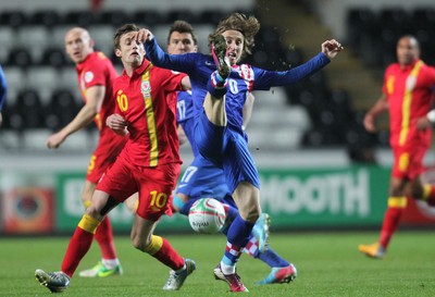 260313 - Wales v Croatia, World Cup Qualifier, Swansea - Croatia's Luka Modric and Wales' Andy King compete for the ball
