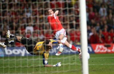 11.10.06...Wales v Cyprus, Euro 2008 Qualifying, Cardiff. Wales'  Jason Koumas and Cyprus keeper Michalis Morphis watch as his shot shaves the Cyprus goalposts 
