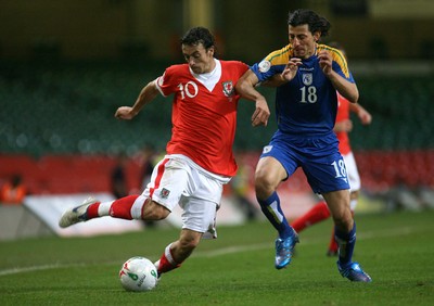 11.10.06...Wales v Cyprus, Euro 2008 Qualifying, Cardiff. Wales' Simon Davies holds off Yiasoumis Yiasoumi 