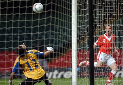 11.10.06 - Euro 2008 Qualifying Match, Group D Wales v Cyprus Wales' Jason Koumas beatd 'keeper Michael Morphis to claim a goal 