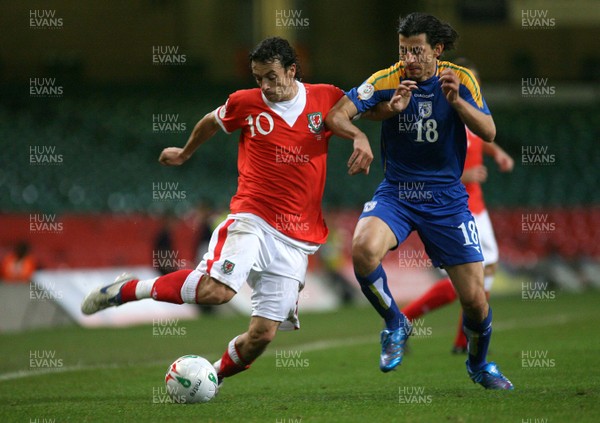 11.10.06...Wales v Cyprus, Euro 2008 Qualifying, Cardiff. Wales' Simon Davies holds off Yiasoumis Yiasoumi 