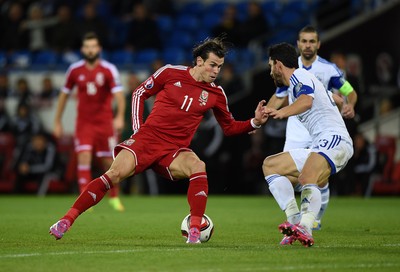 131014 - Wales v Cyprus - UEFA European Championship - Gareth Bale of Wales gets past Marios Nikolaou of Cyprus 
