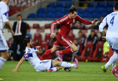 131014 - Wales v Cyprus - UEFA European Championship - Gareth Bale of Wales is tackled by Marios Nikolaou of Cyprus 
