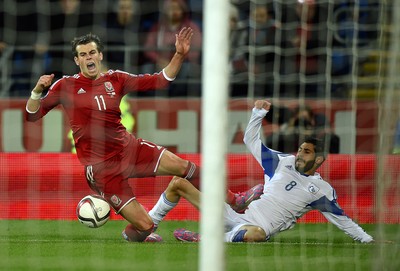 131014 - Wales v Cyprus - UEFA European Championship - Gareth Bale of Wales is tackled by Charis Kyriakou of Cyprus 