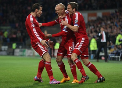 131014 - Wales v Cyprus, UEFA European Championship Qualifier - Wales' David Cotterrill celebrates with Gareth Bales and Andy King after scoring goal