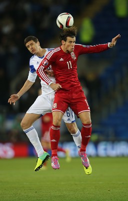 131014 - Wales v Cyprus, UEFA European Championship Qualifier - Wales' Gareth Bale beats Angelis Angelis of Cyprus to head the ball