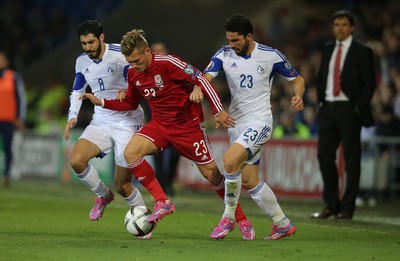131014 - Wales v Cyprus, UEFA European Championship Qualifier - Wales' George Williams takes on Charis Kyriakou and Marios Nikolaou of Cyprus