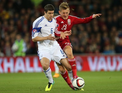 131014 - Wales v Cyprus, UEFA European Championship Qualifier - Wales' George Williams is challenged by Angelis Angelis of Cyprus